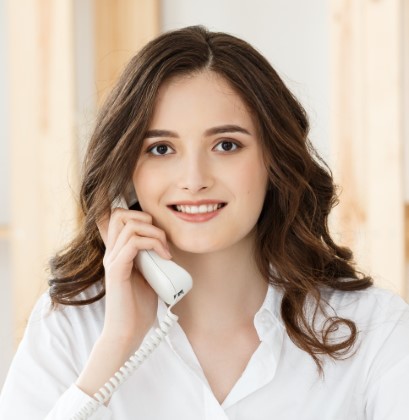 Young woman talking on phone in modern office